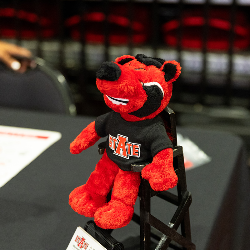 plushie howl mascot in chair