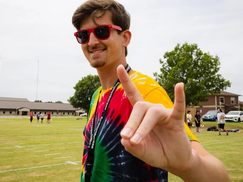 A participant of Band Camp puts his Wolves Up