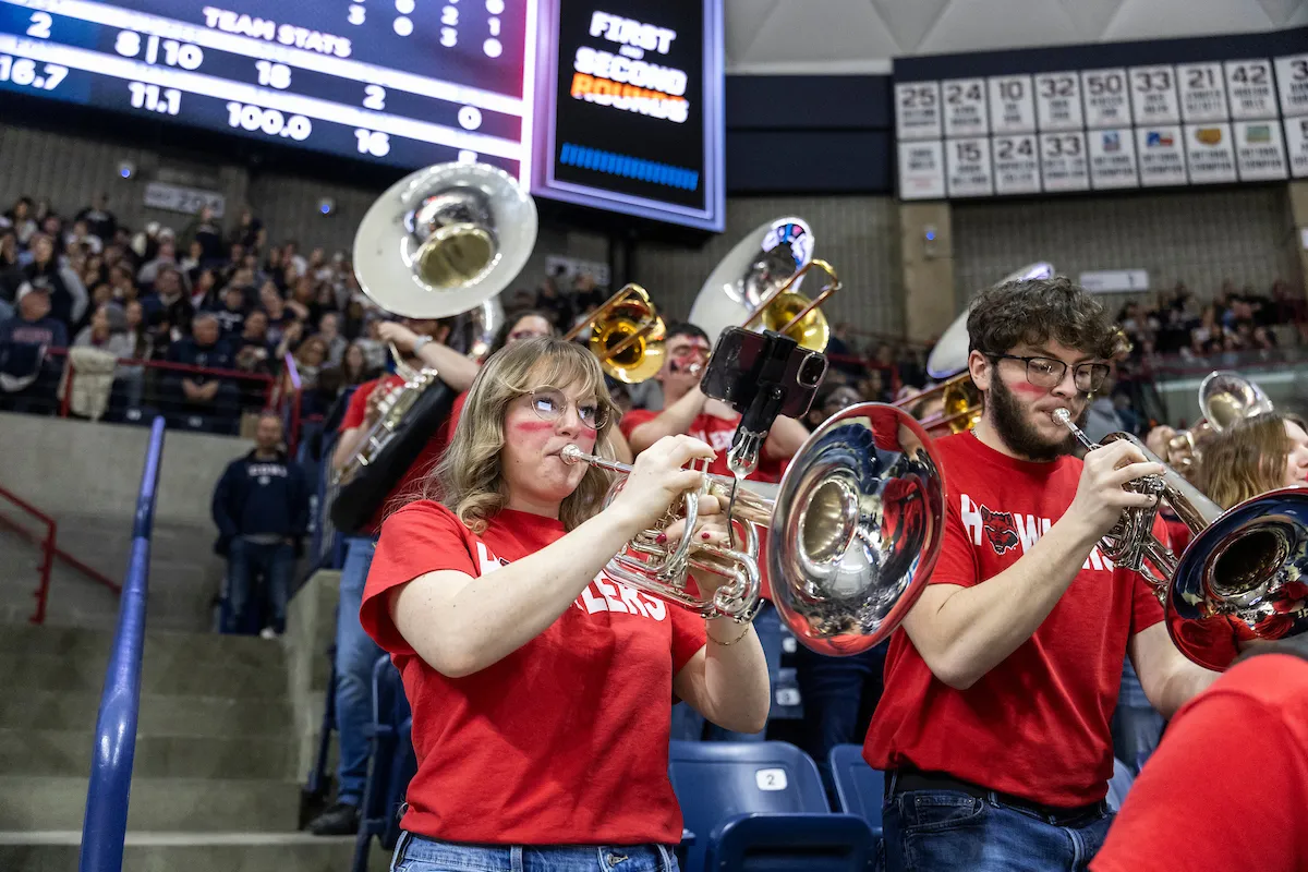 The howler pep band performs at a basketball game