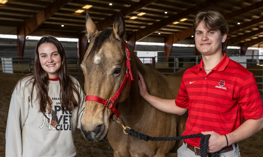 Pre-Vet students pose with a horse at this equine
