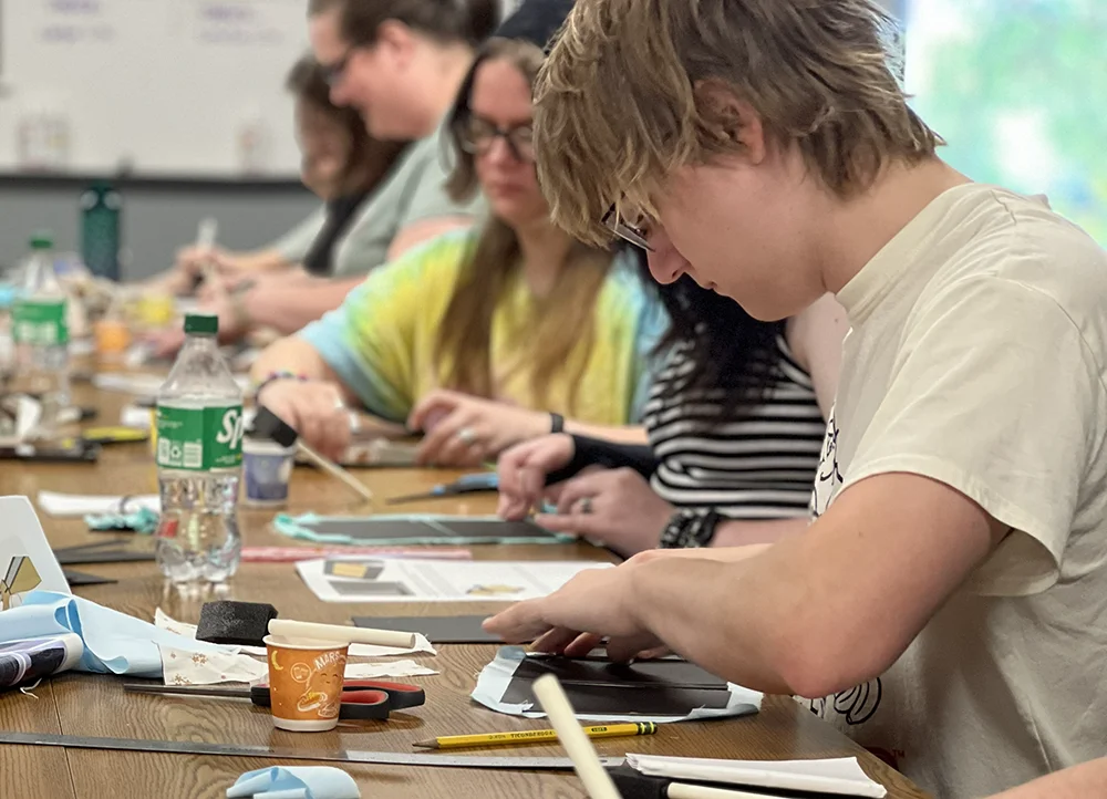Graphic design students at A-State's Collage Night doing collage works.