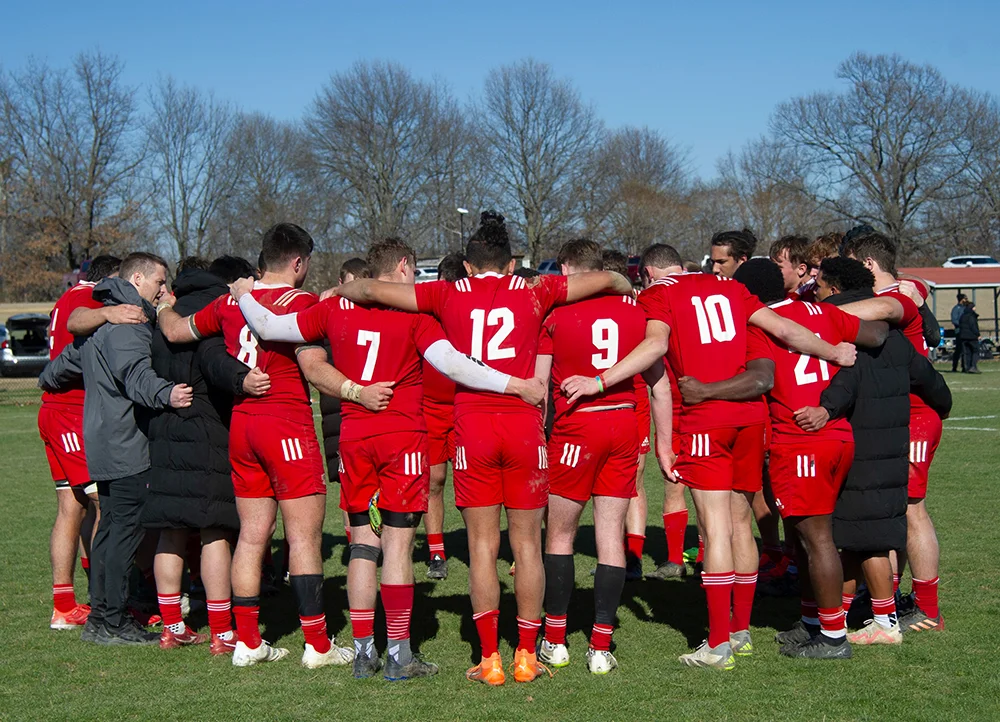 The A-State Rugby team huddling.