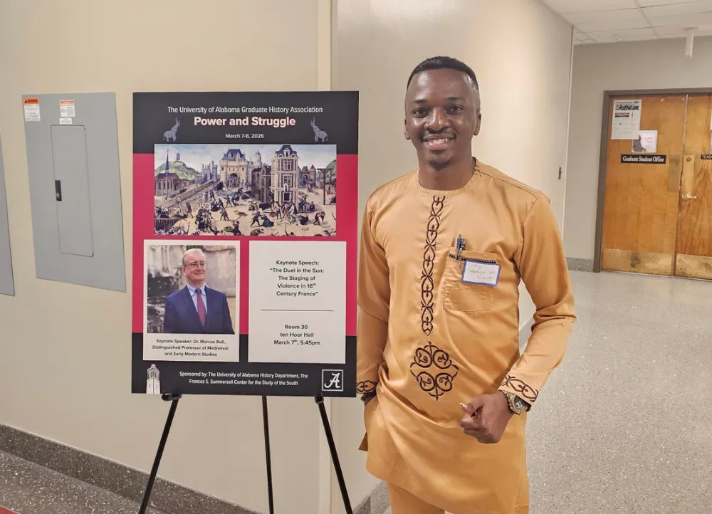 Lucky Ihedigbo presenting power and struggle research for the A-State graduate school.