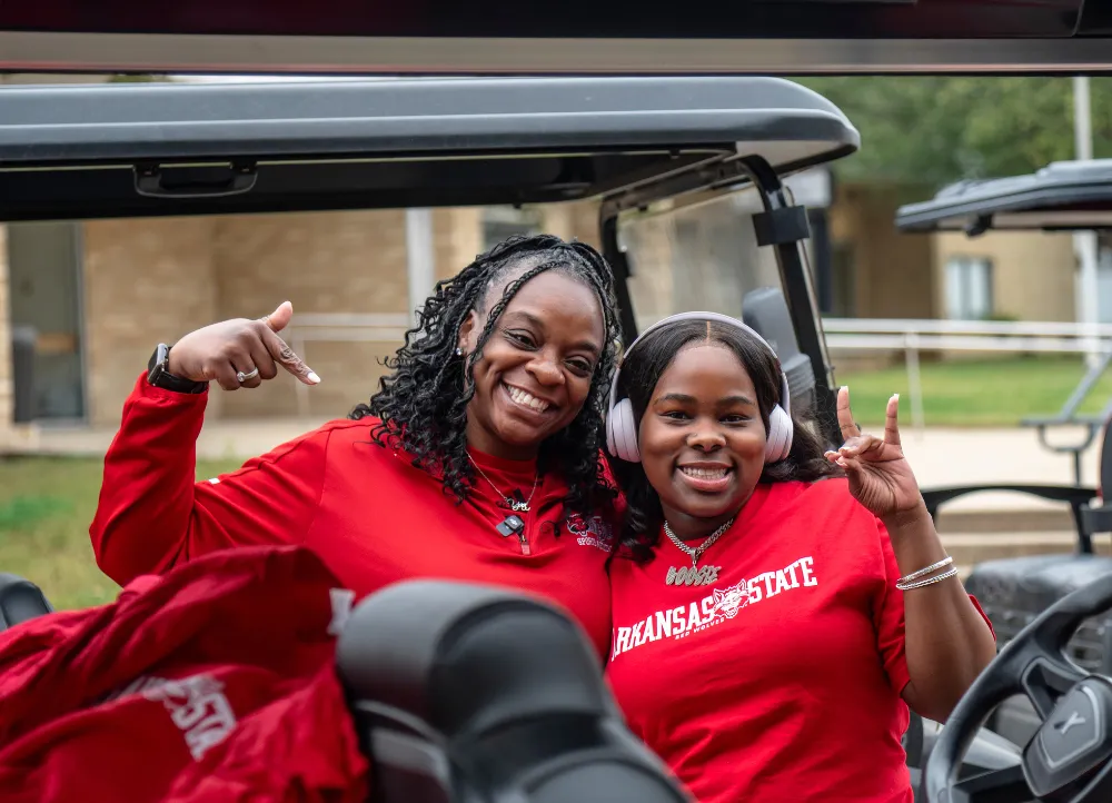 Student using a golf cart with transportation services.