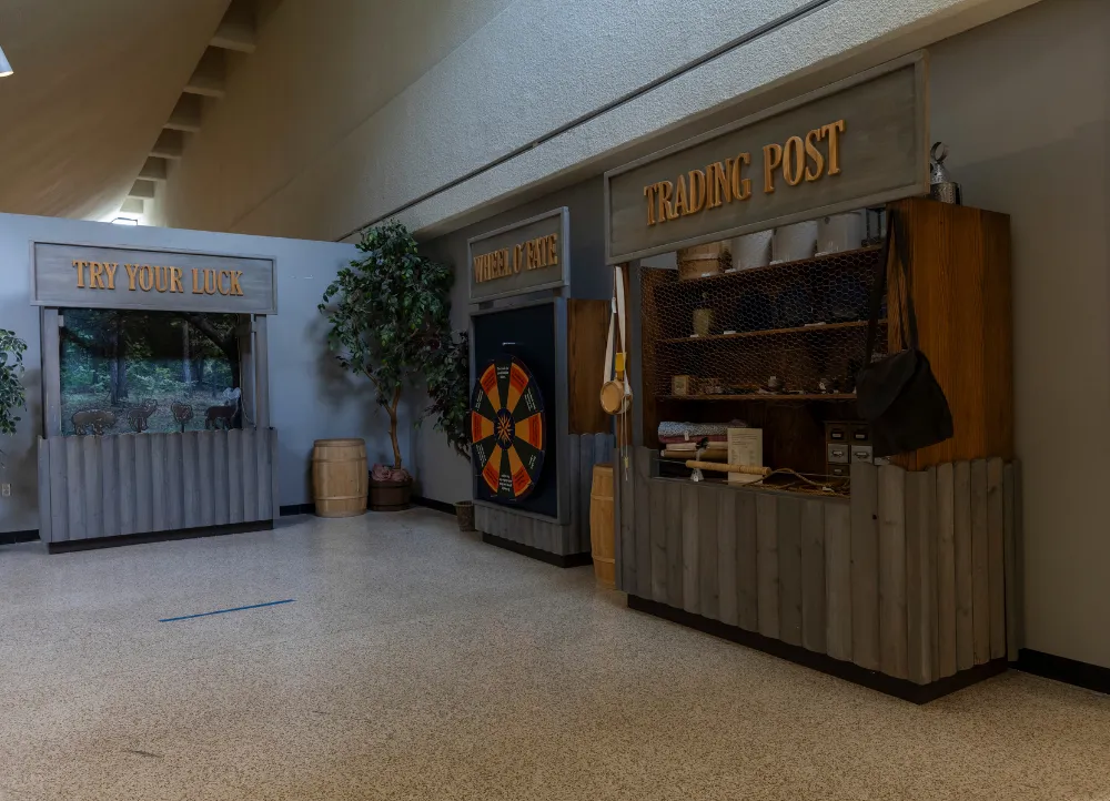 Trading post and old dart game set up on exhibit.
