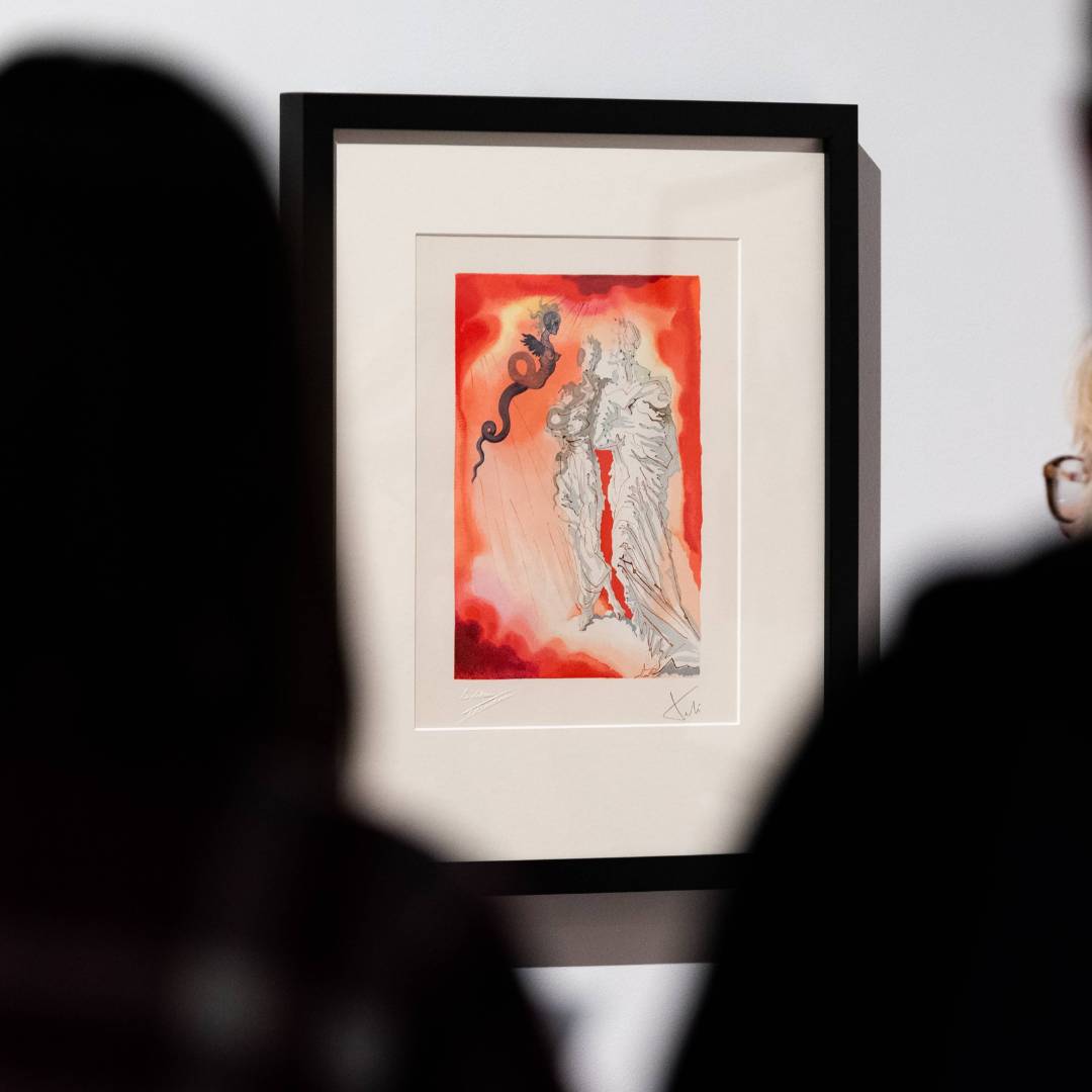 Two silhouetted people looking at a watercolor painting mounted on a white wall
