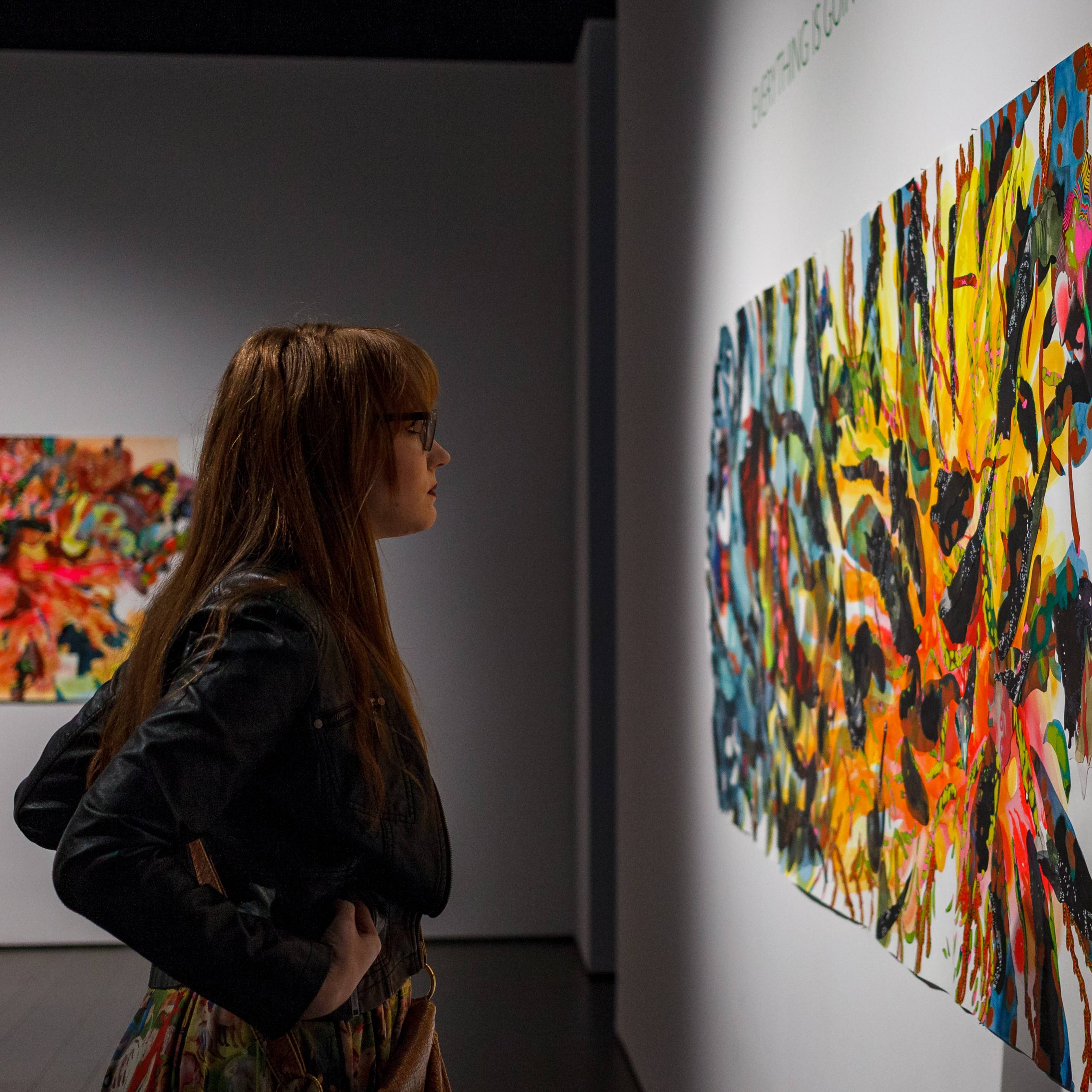 A person in the Bradbury Art Museum looking at an abstract painting