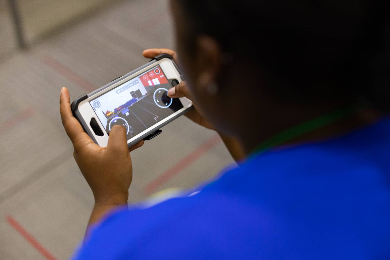 A student playing a mobile app game prototype