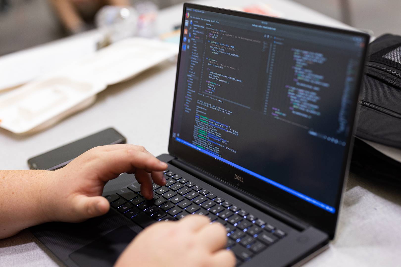 A close-up photo of a laptop with code on the screen