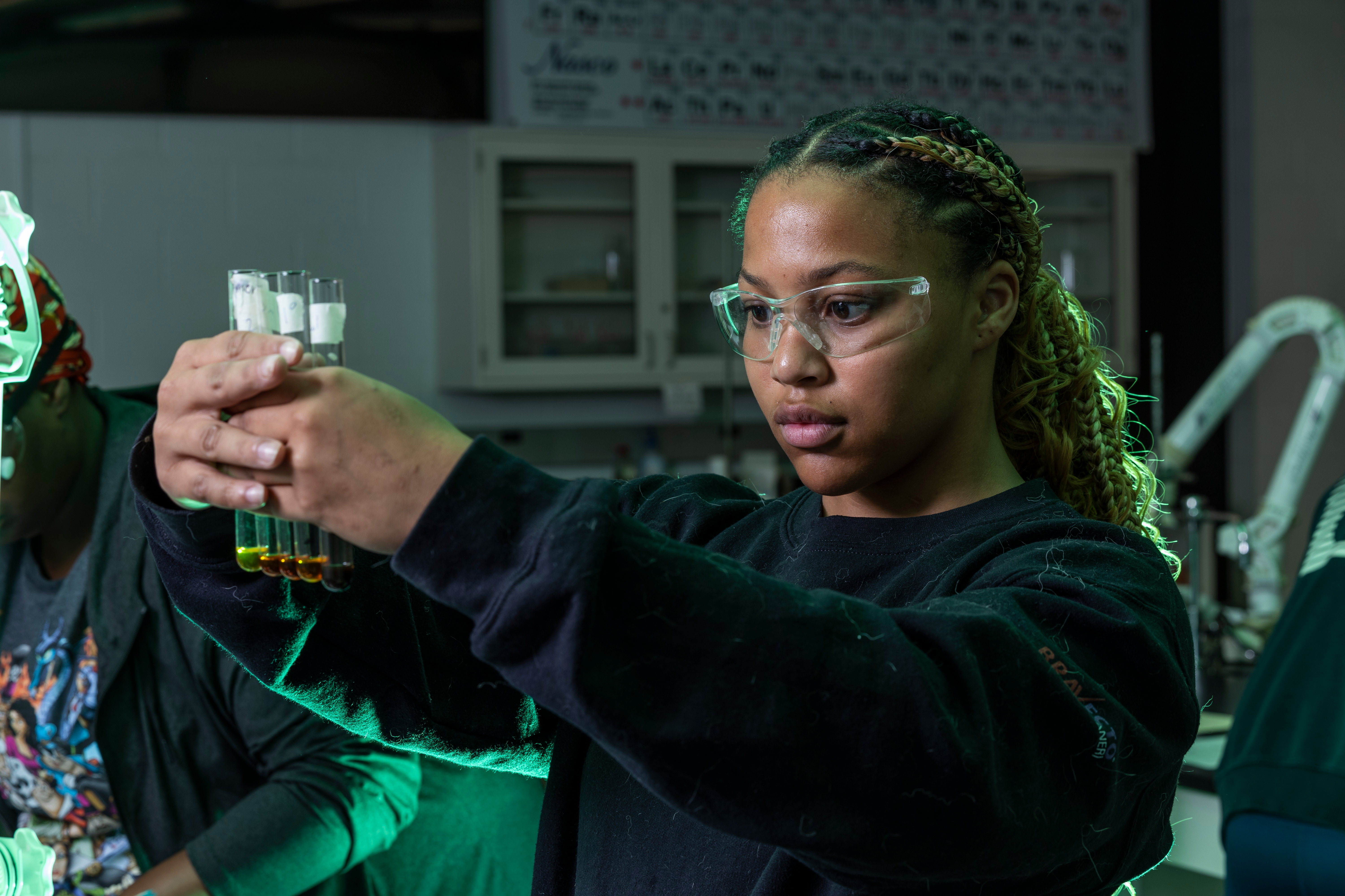 A student inspecting test tubes.