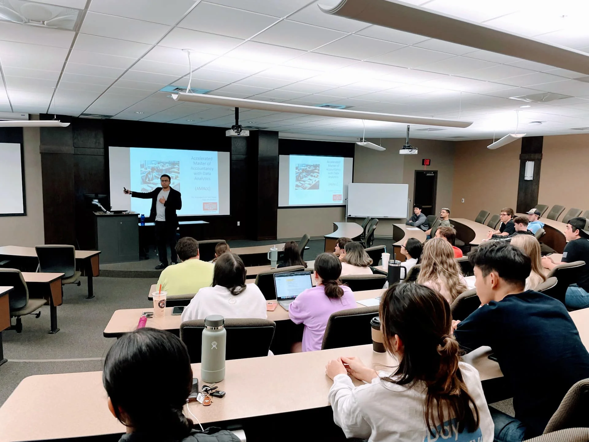 Accounting class going over equations with students engaged and asking questions.
