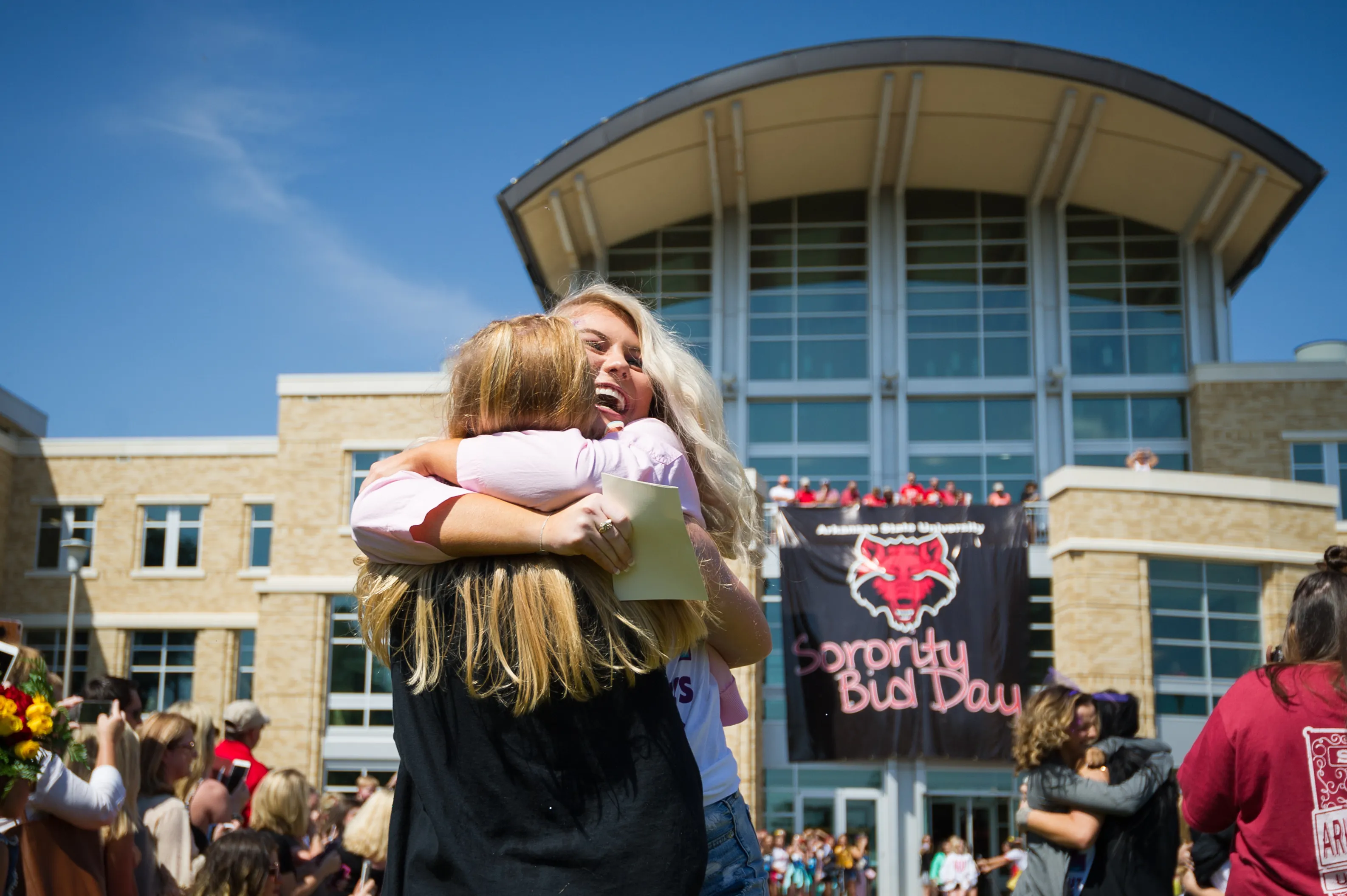 Campus students celebrating outside of the Student Union building.