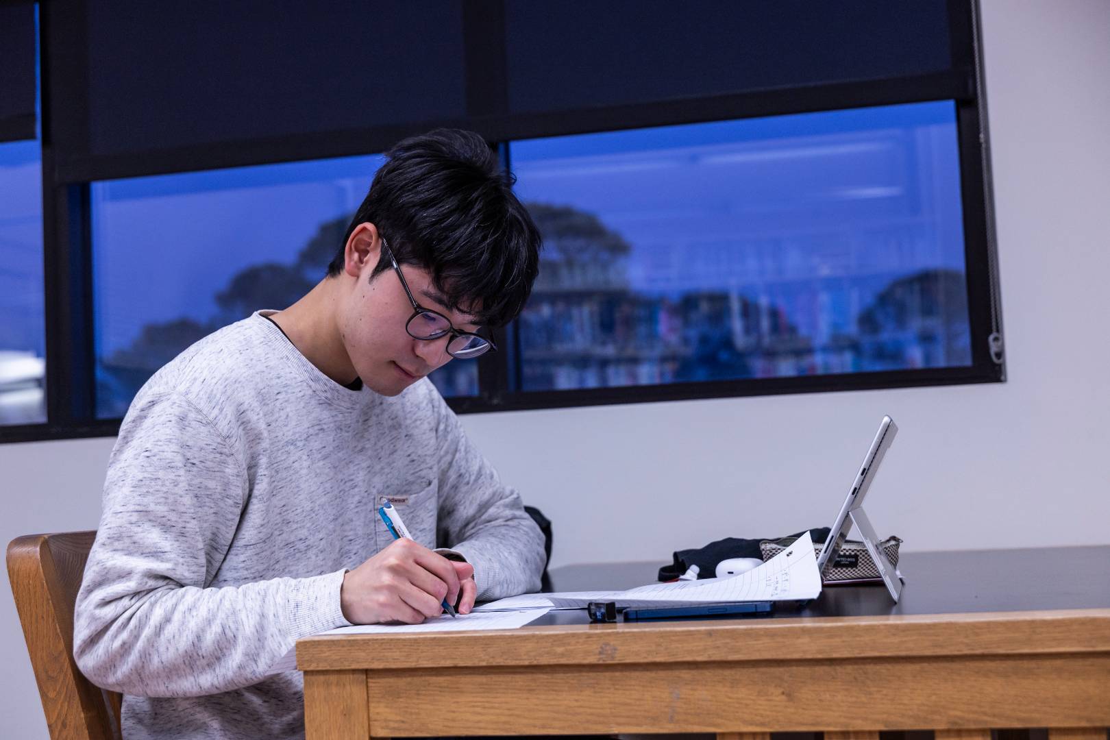 A student sitting at a desk and doing homework.