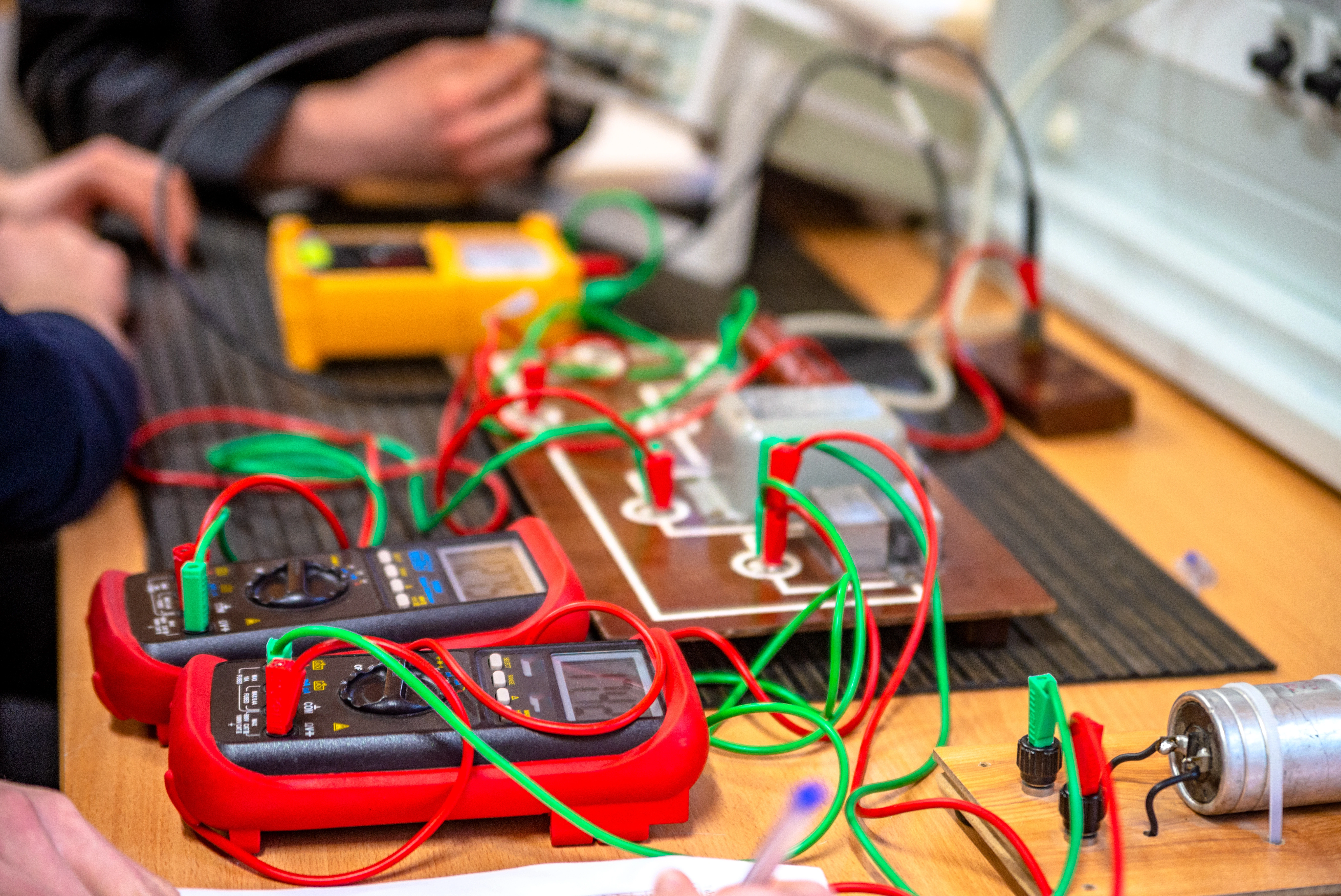 Electrical engineering class with voltmeter on table.
