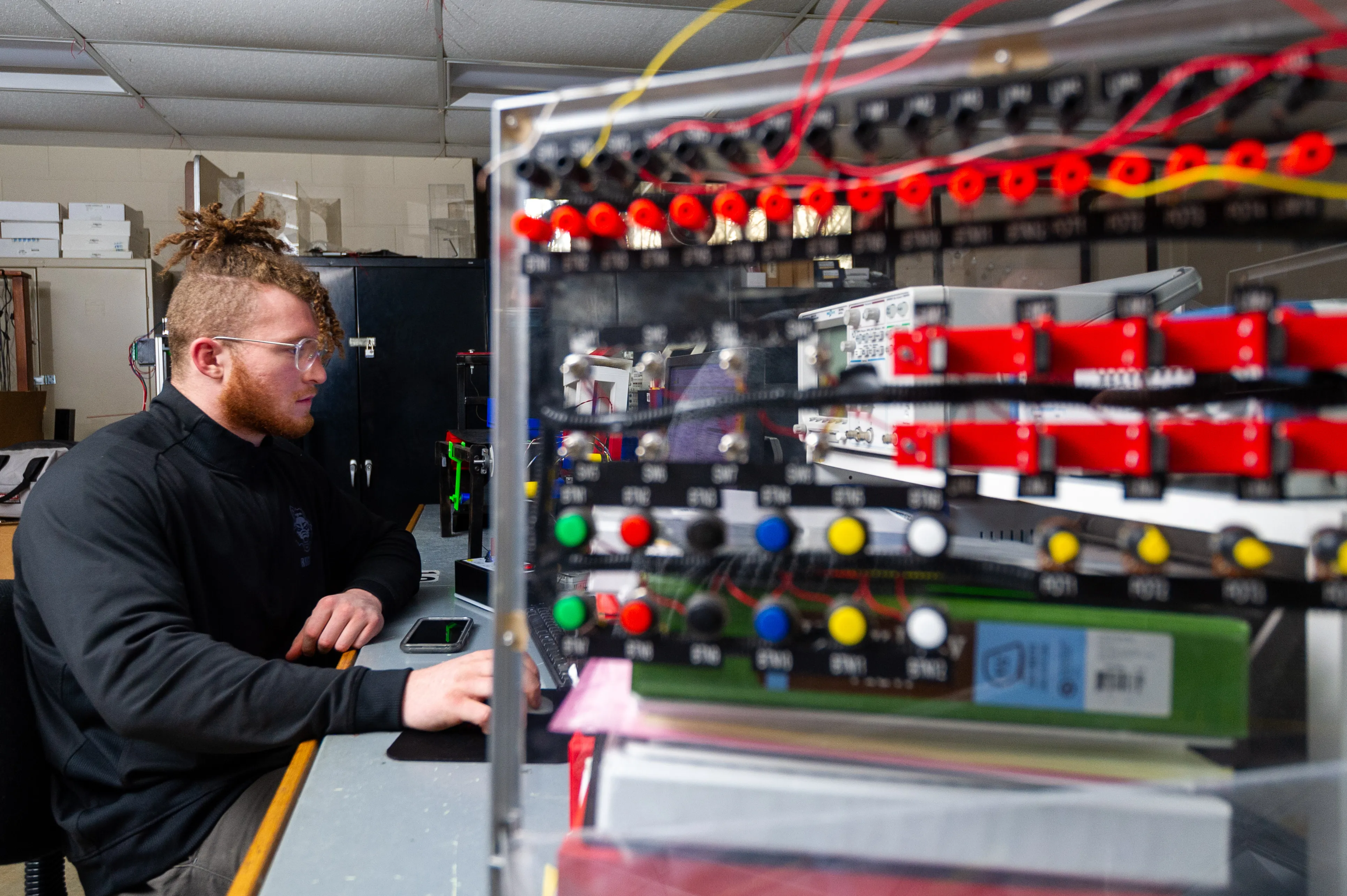 Engineering Tech student working on advanced engineering machine.