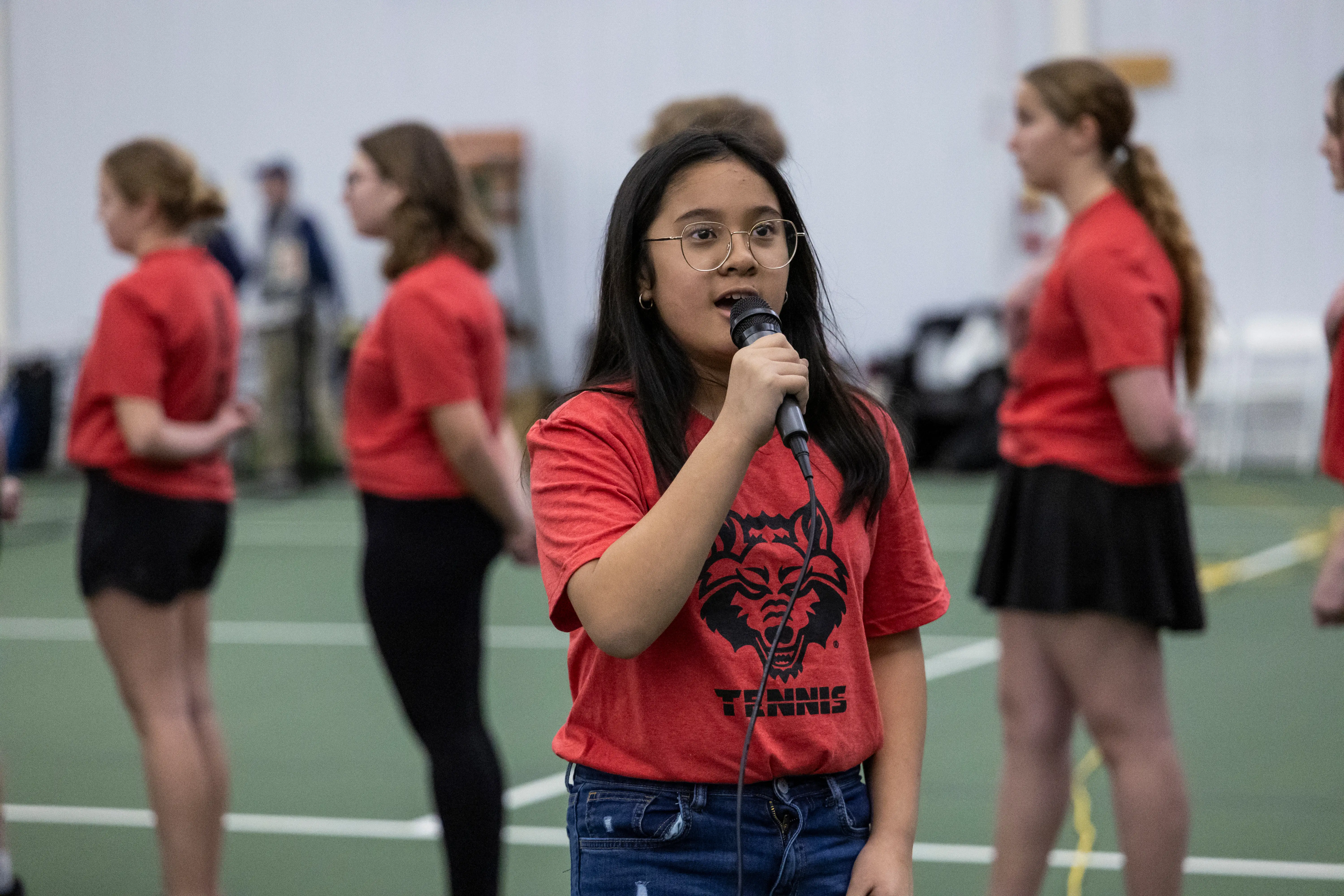 A student singing into a microphone.