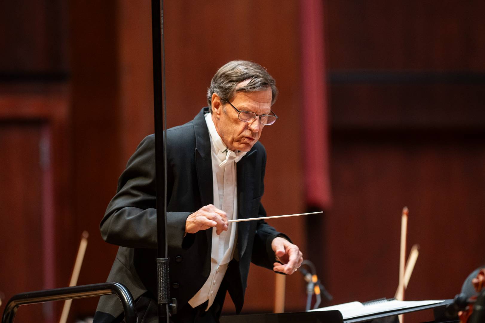 A conductor conducting an orchestra.