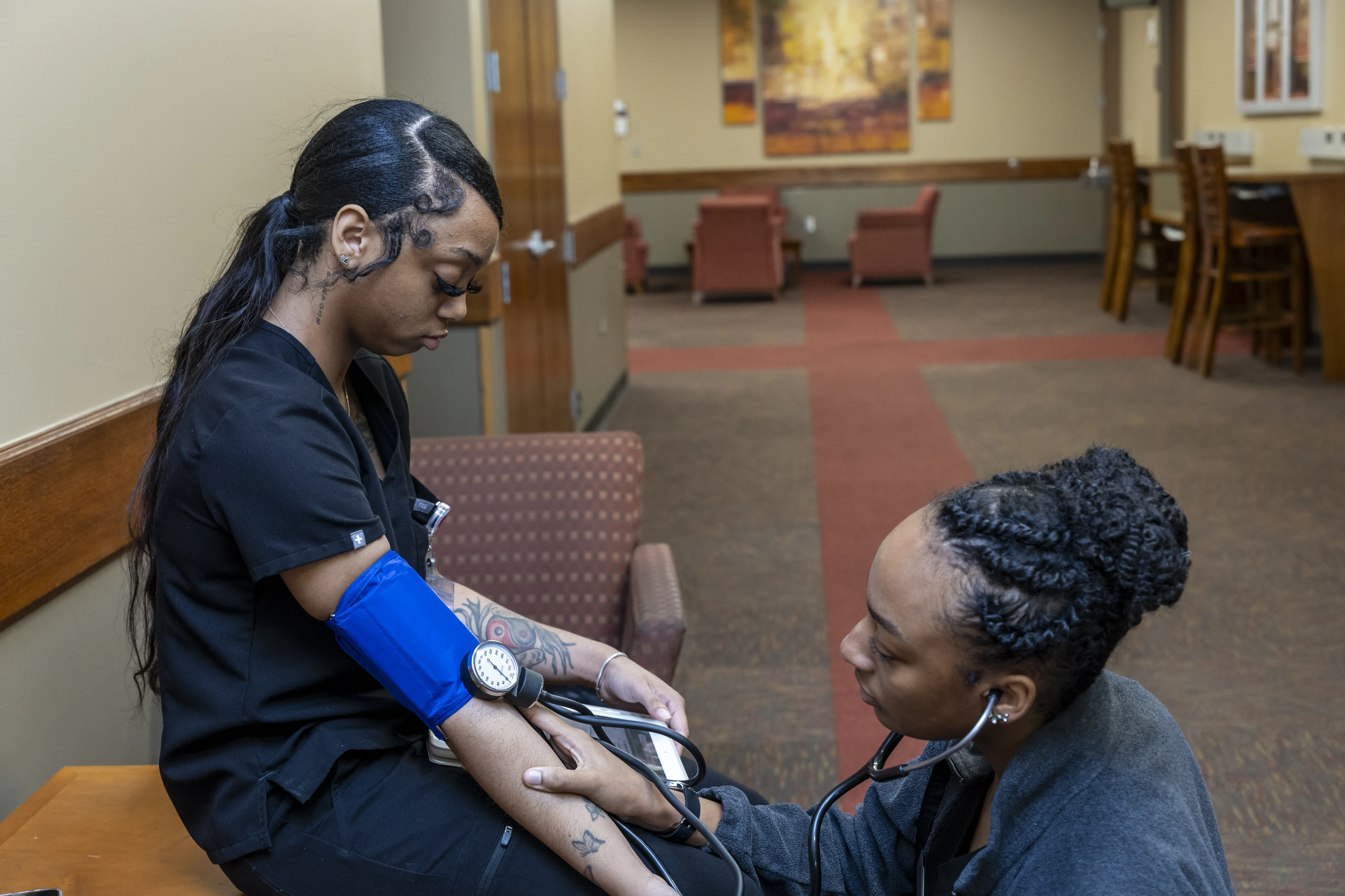 Nursing students practicing checking vitals.