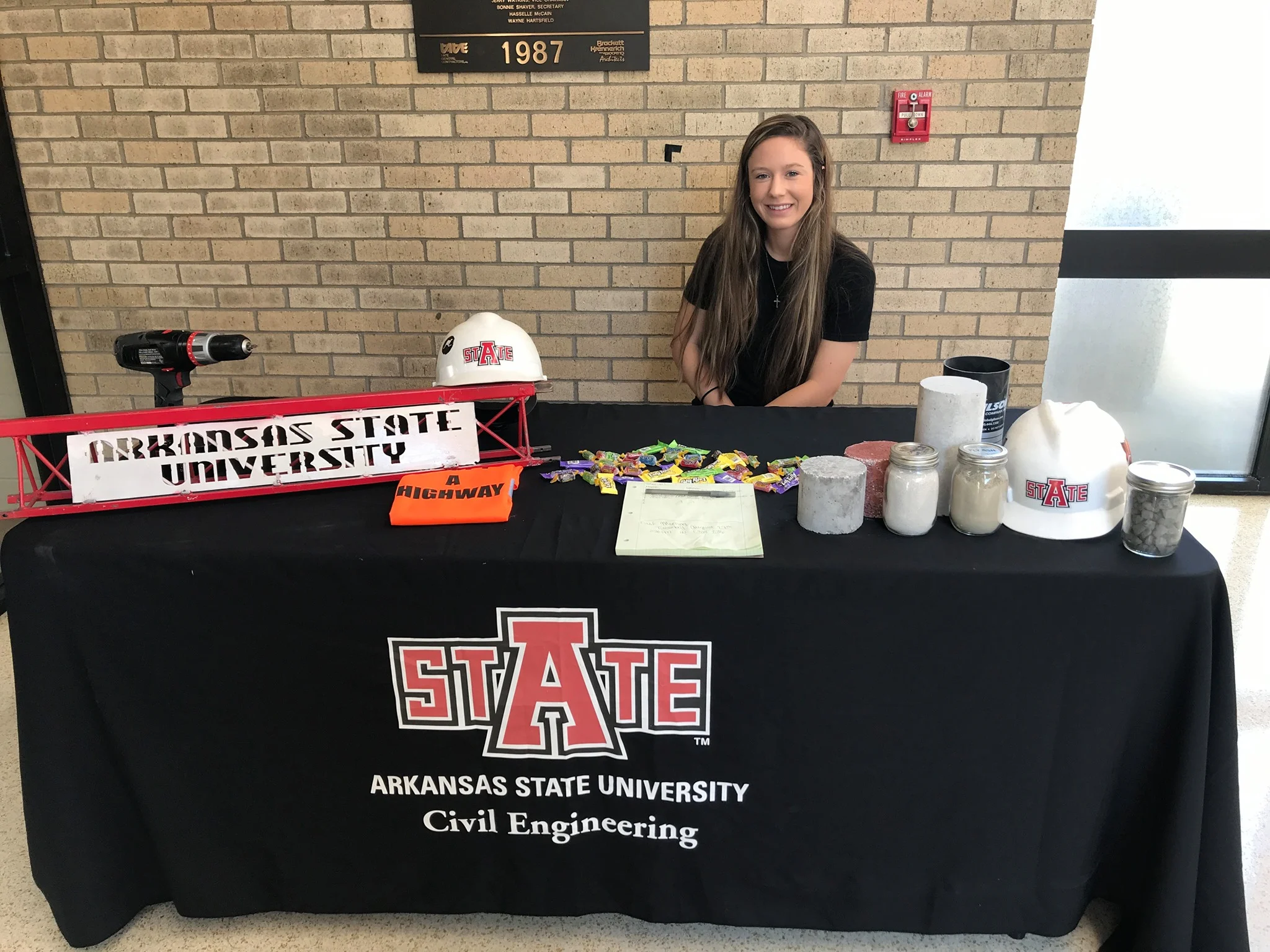 Paige Leissner at the civil engineering booth handing out various things.