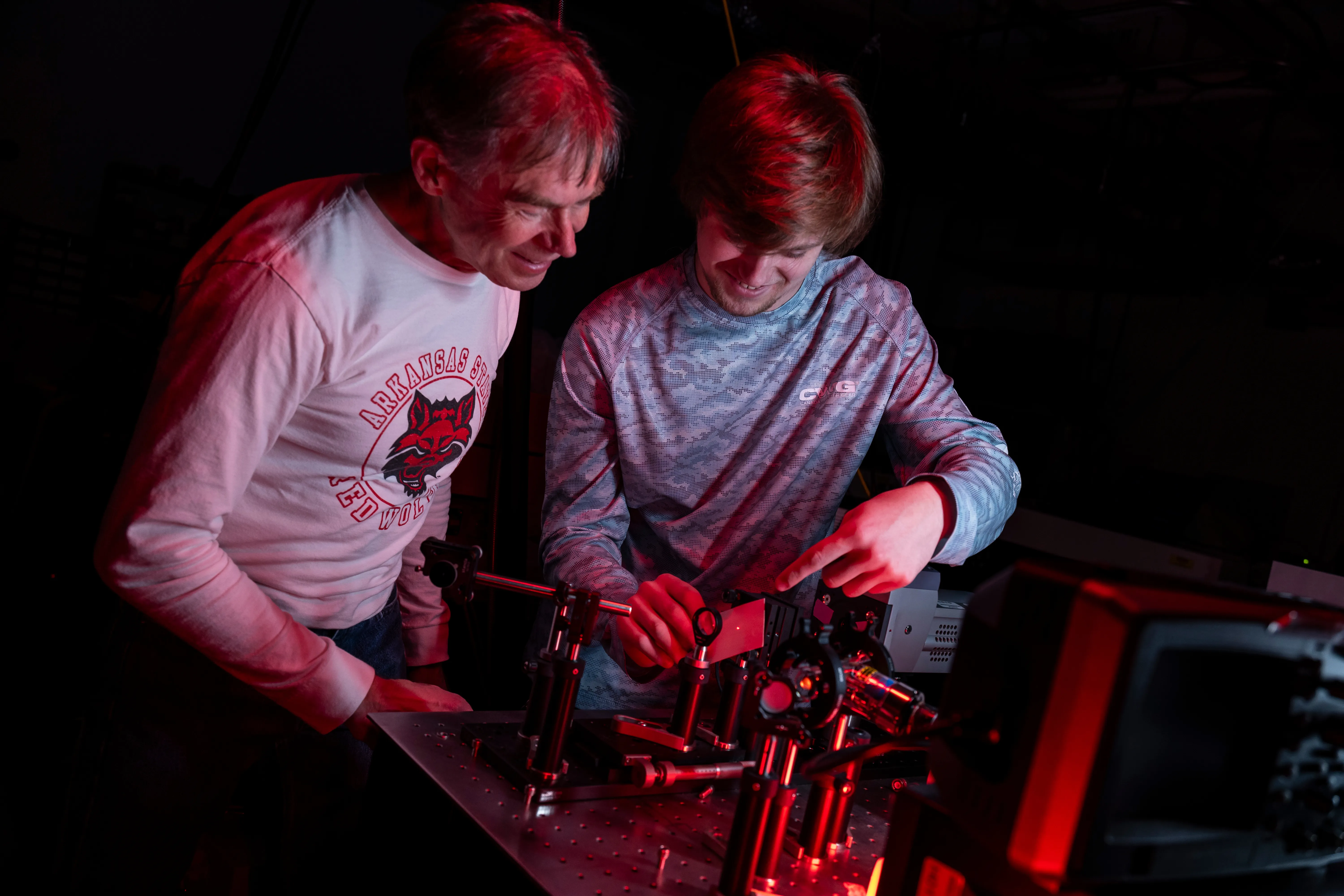 A professor and student doing an experiment together.