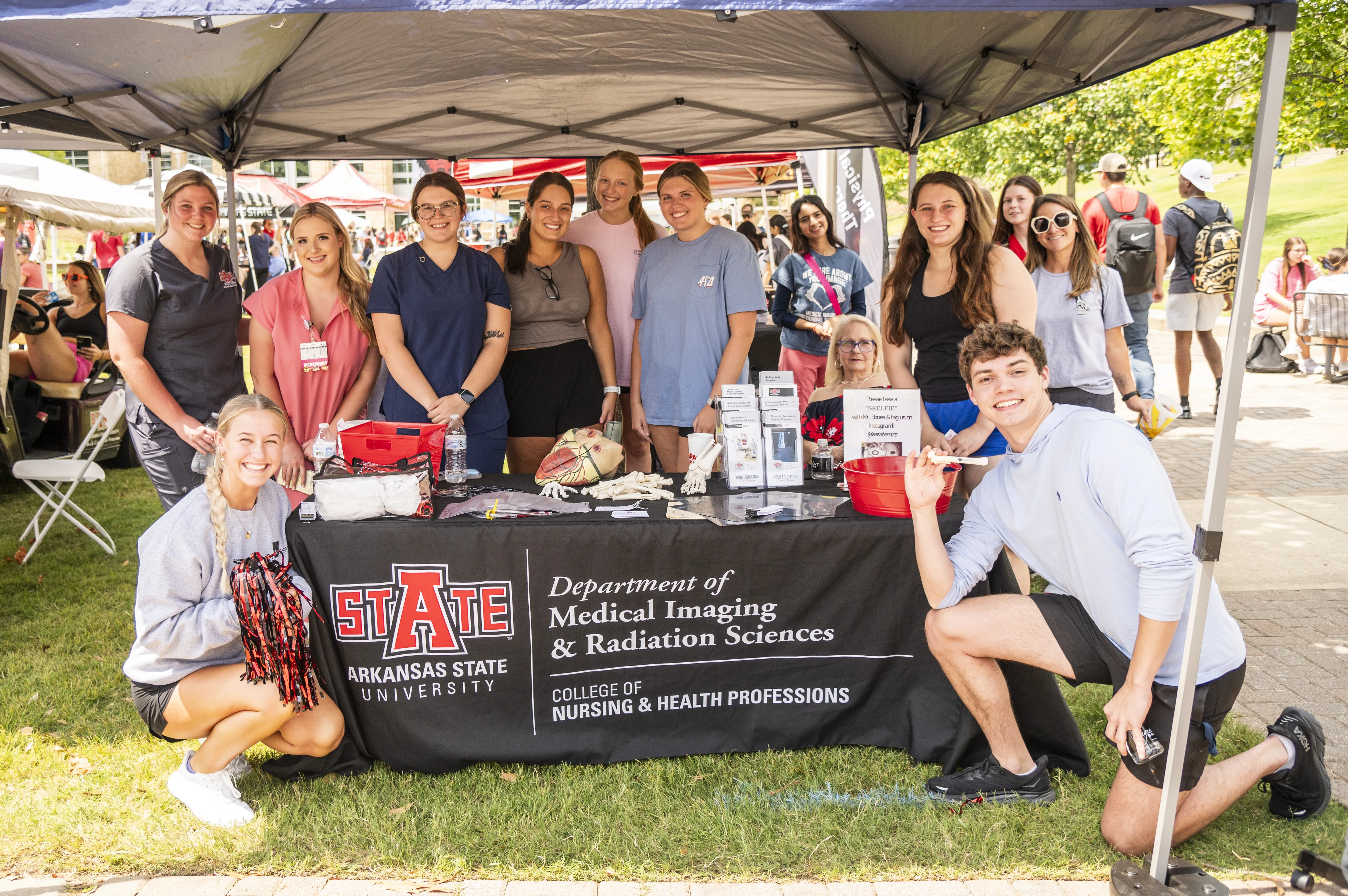 Radiology students at tent during a fair type event.