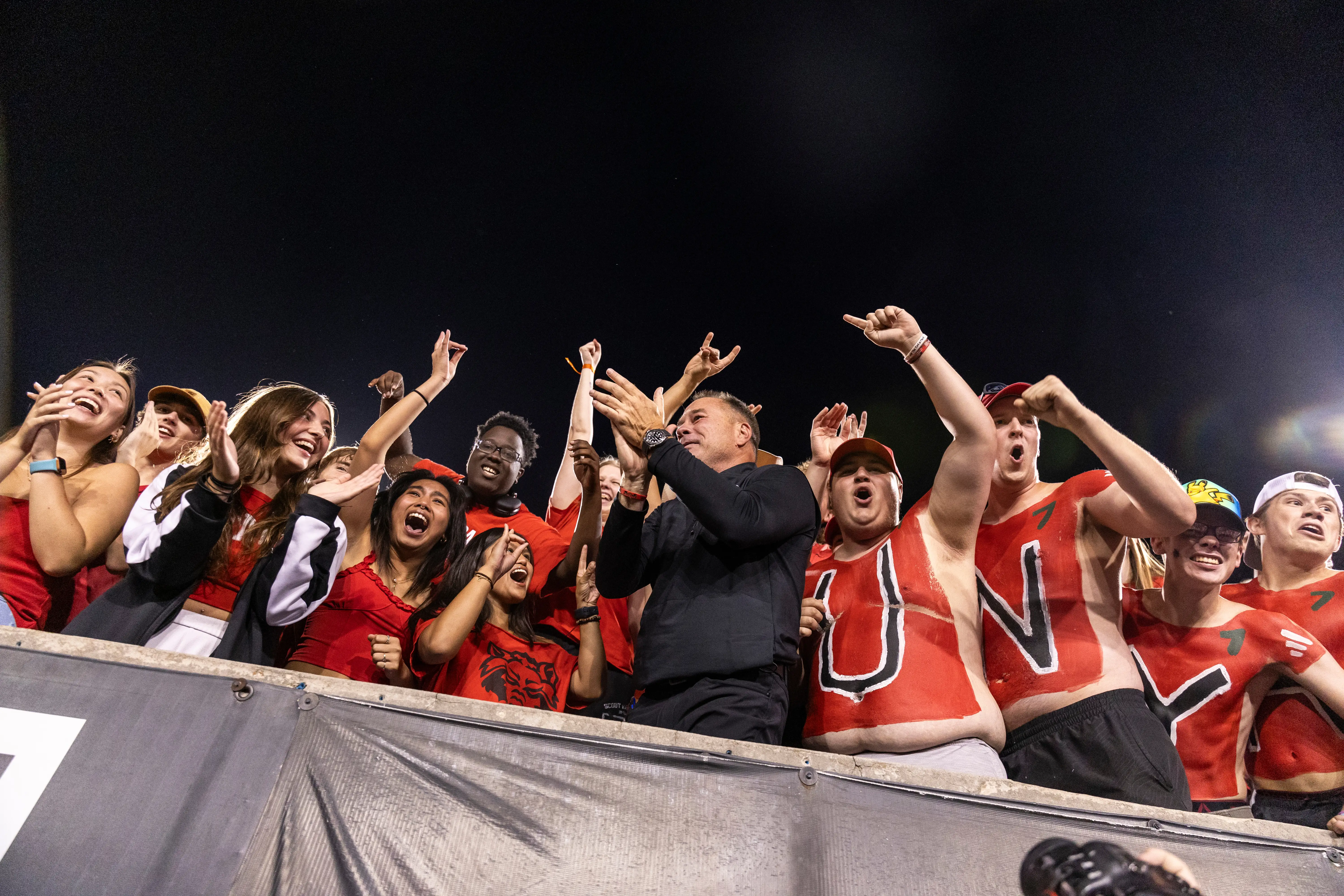 A crowd cheering at a Red Wolves game.