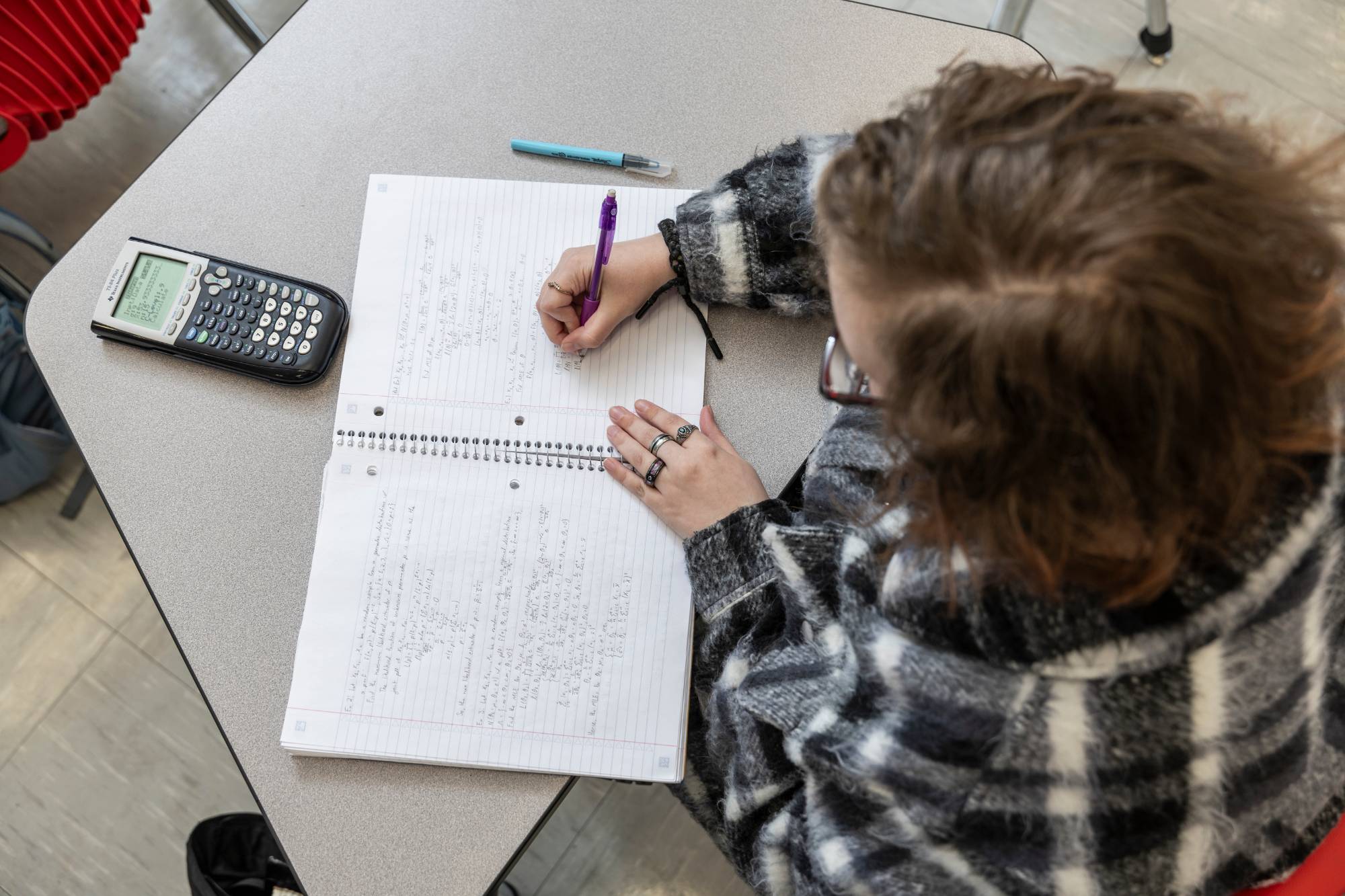 Top-down view of a student doing math equations.
