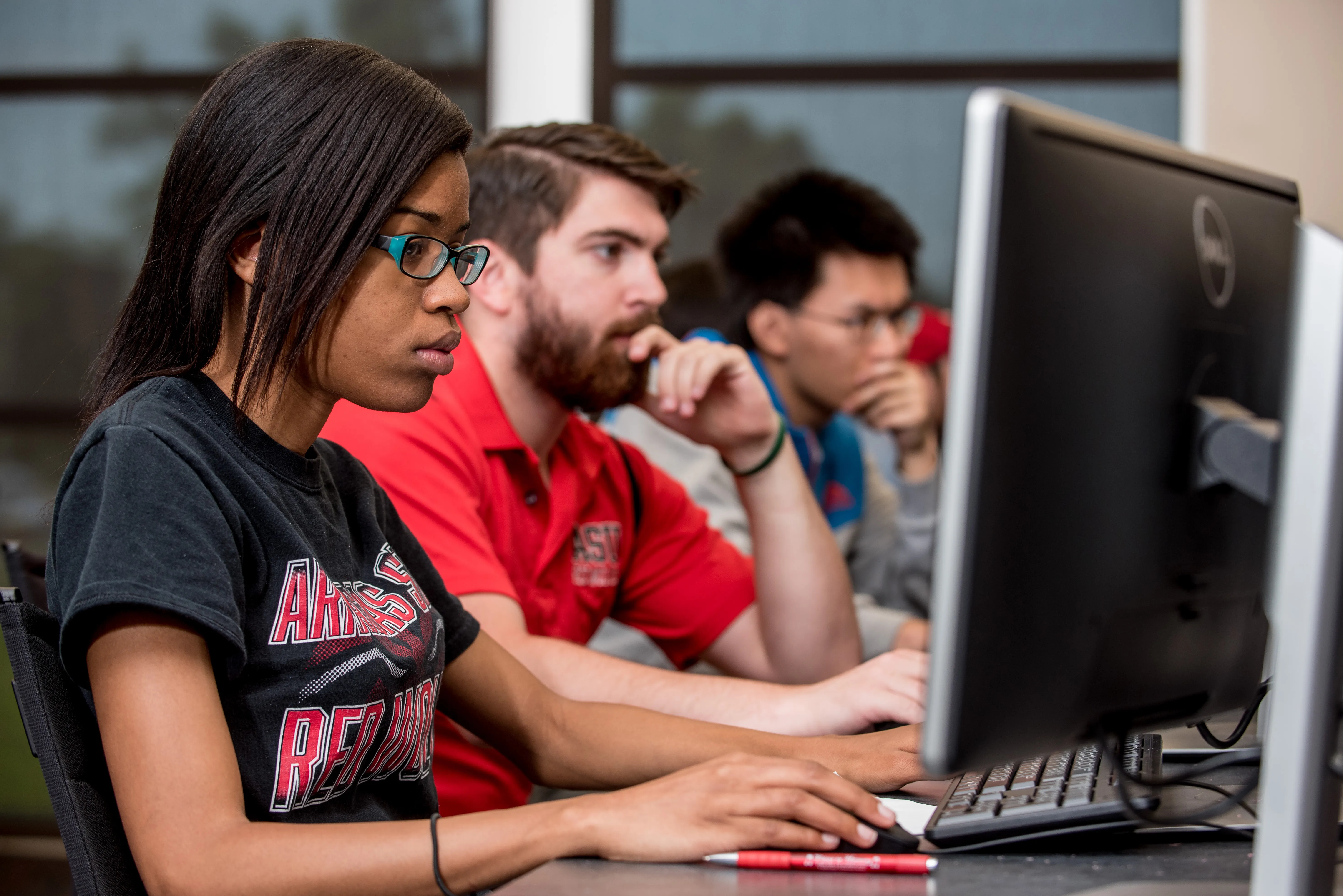 a-state student working on data analytics in the dawson economics lab.