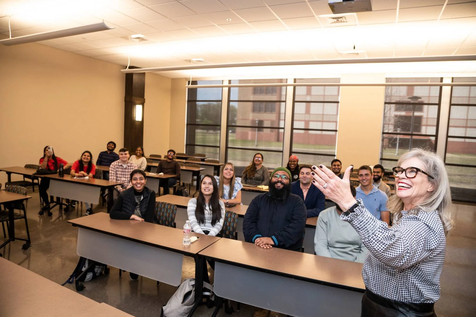 A-State communications class smiling at lecture being presented.