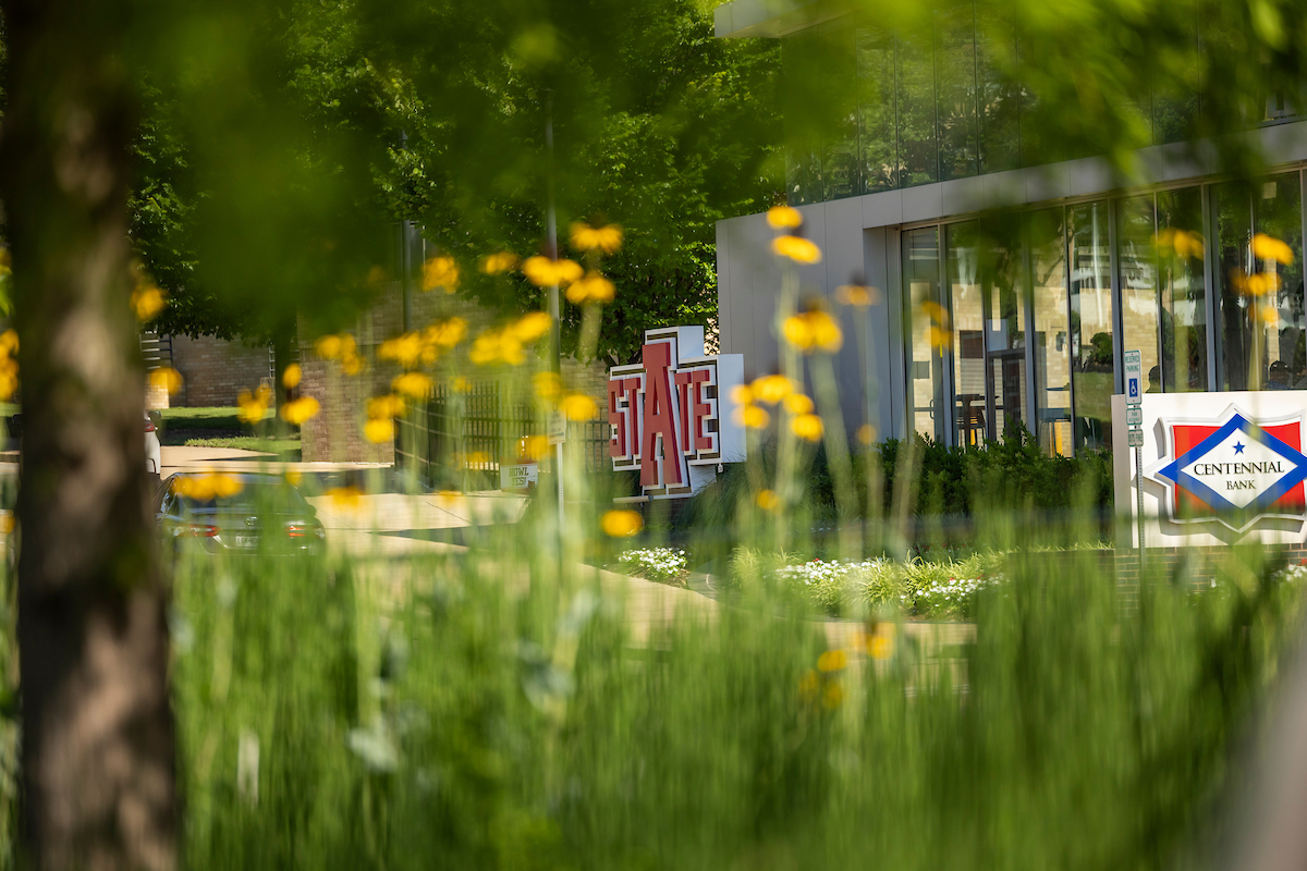 Summer flowers bloom in front of the Welcome Center and on-campus Centennial Bank location.