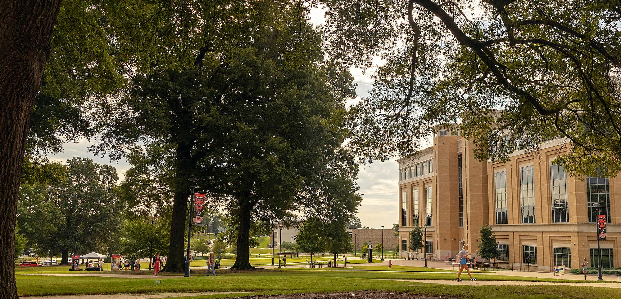 view of the Humanities & Social Sciences building, with students walking past