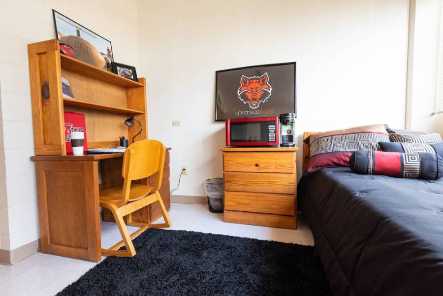 Arkansas Hall Bedroom with desk and microwave on bedside chest of drawers