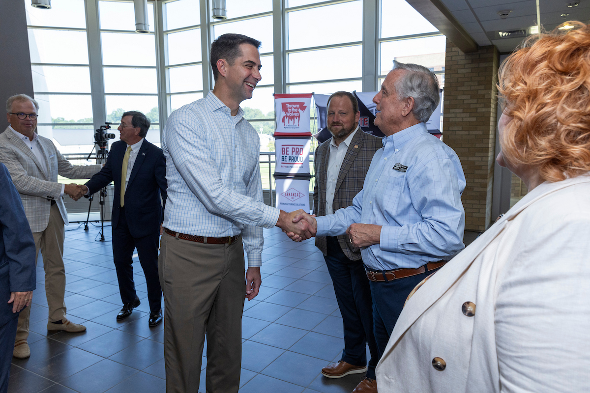 Businessmen give a handshake in the lobby of the Delta Center for Economic Development.
