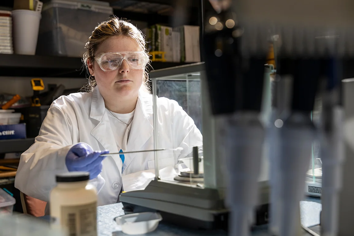 A student performing tests in a lab.