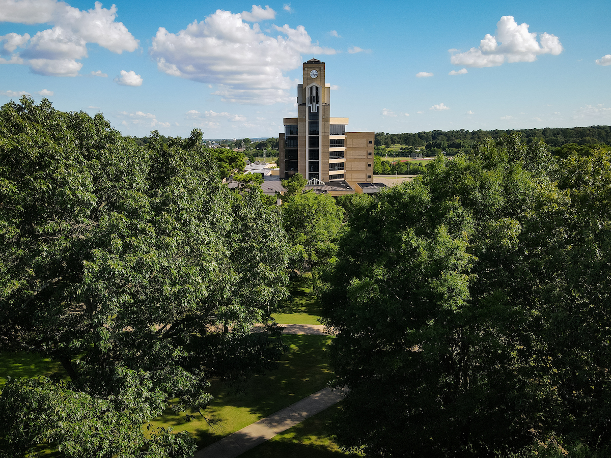 Aerial view of the Dean B. Ellis Library surrounded by trees.