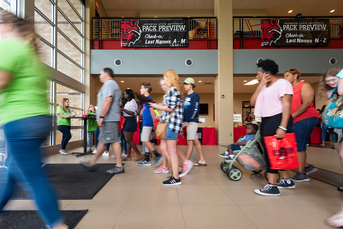 Students and families check in during orientation.