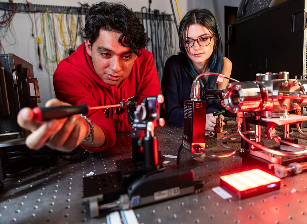 Two physics students working on a project together.