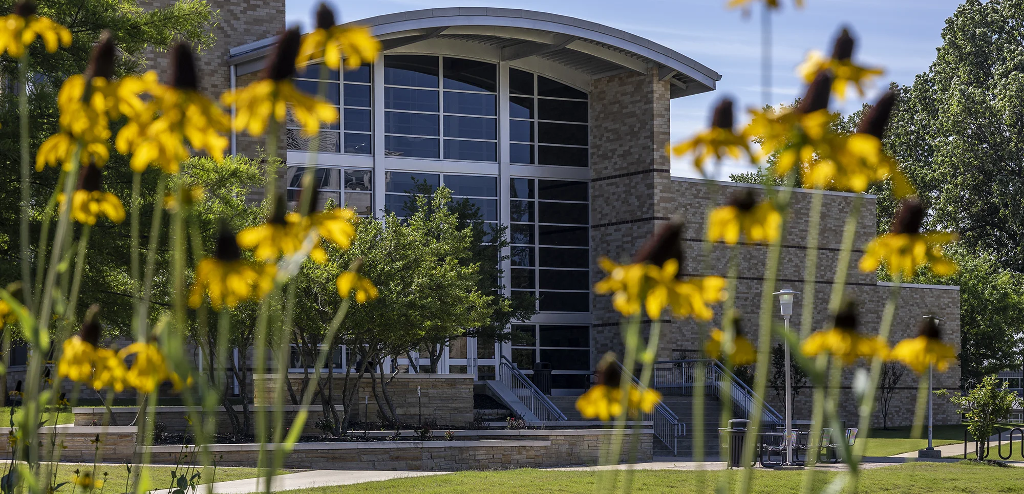 The Red W.O.L.F. Center, framed by yellow flowers.