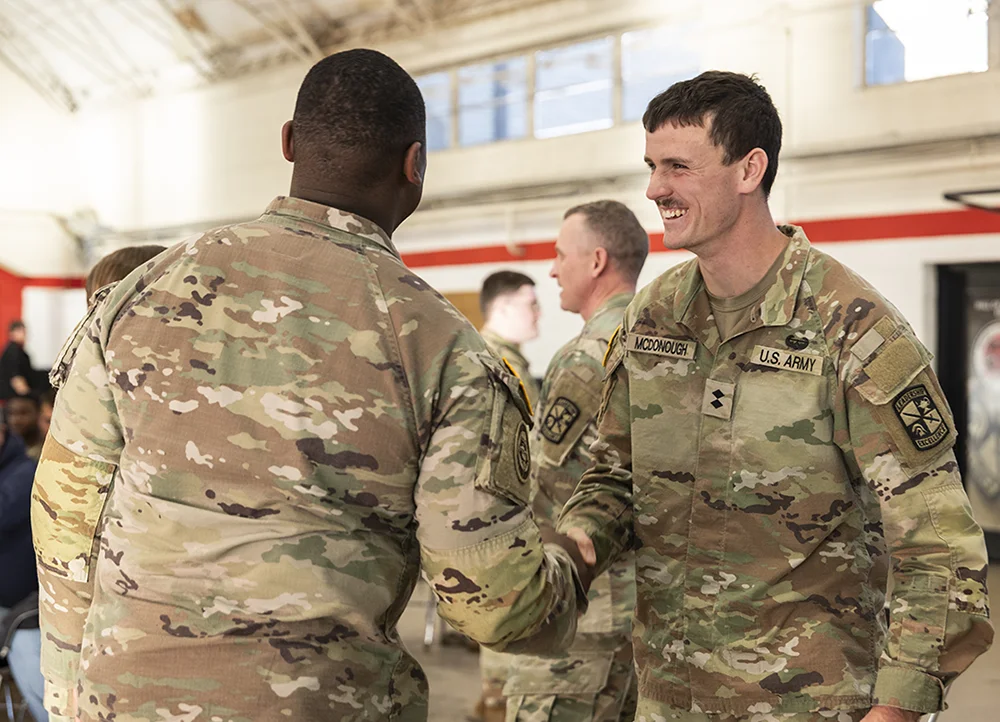 A-State ROTC cadet shaking hands with an armyman.