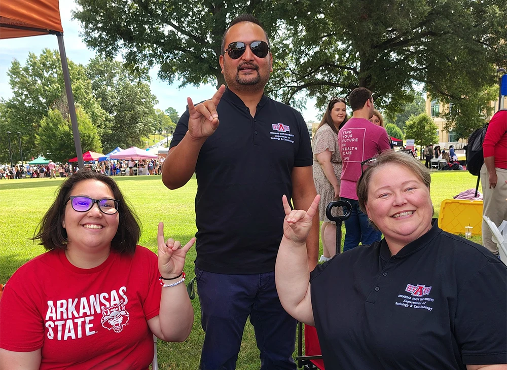 Members and faculty from the Sociology and Criminology department giving Wolves Up.