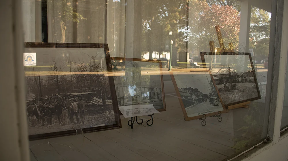 A-State student's photography work on display in a glass case.