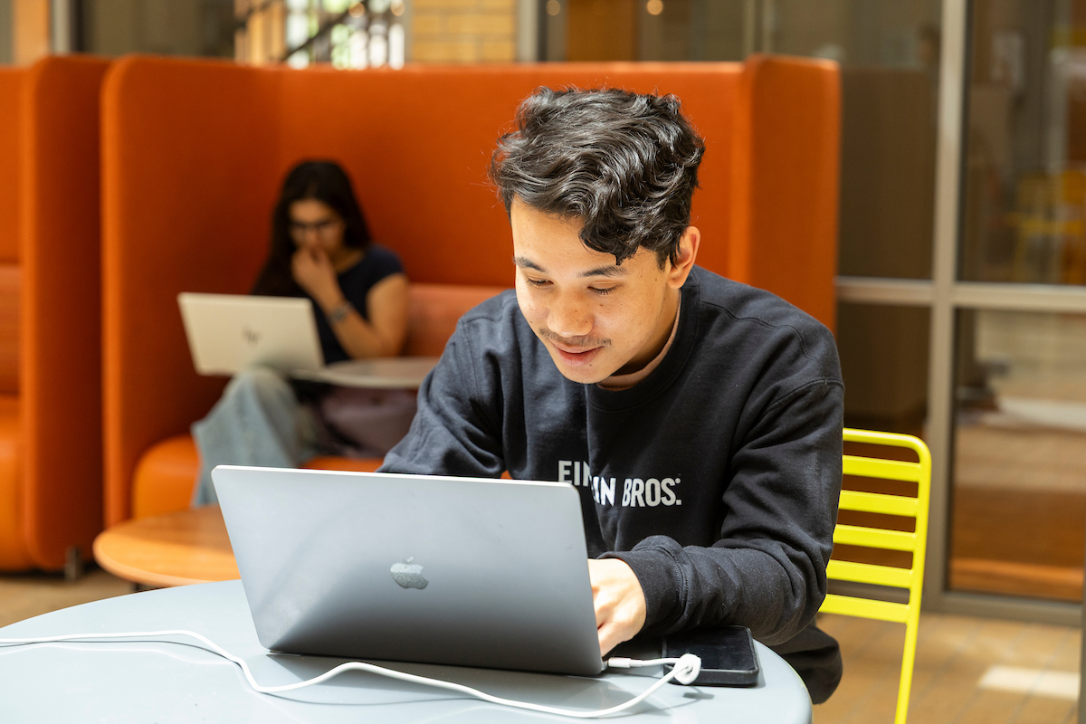Students work on laptops in the HHS building.