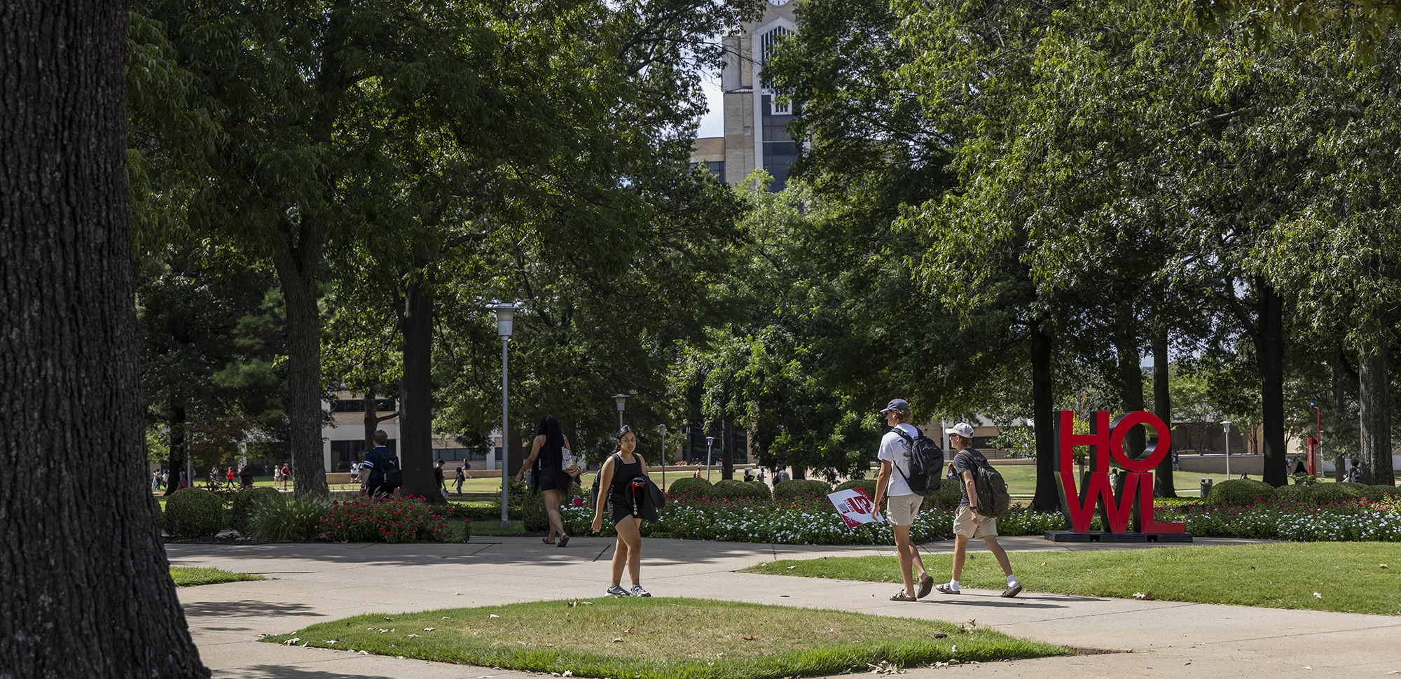 A-State students walking on campus in the summer.