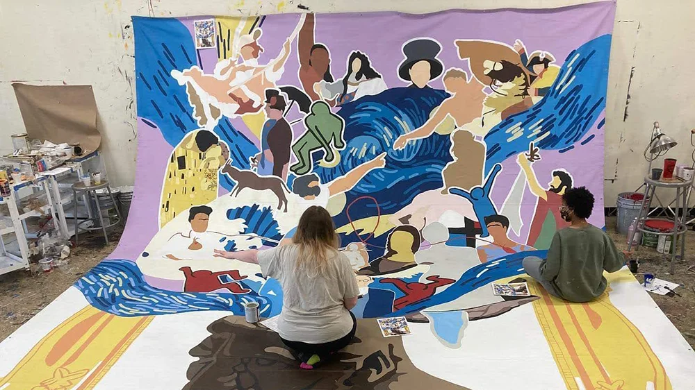 A-State students painting the mural that now hangs in the Fine Arts Center lobby.