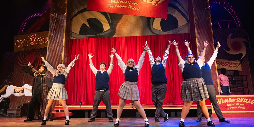 Actors pose together on stage during "Ride The Cyclone".