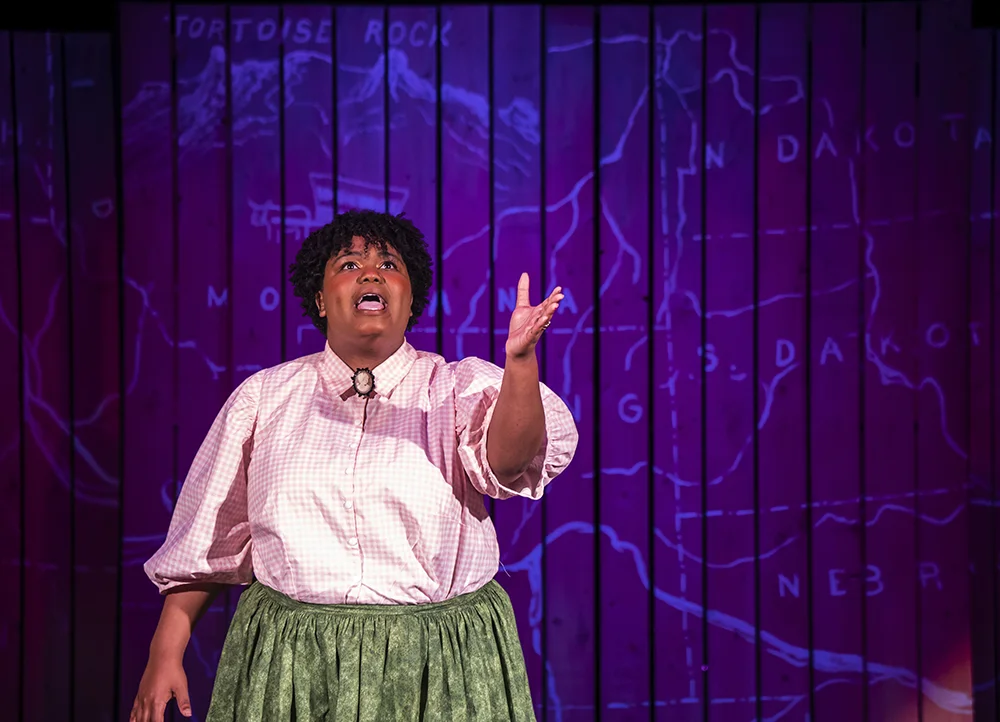 An actress singing alone on stage