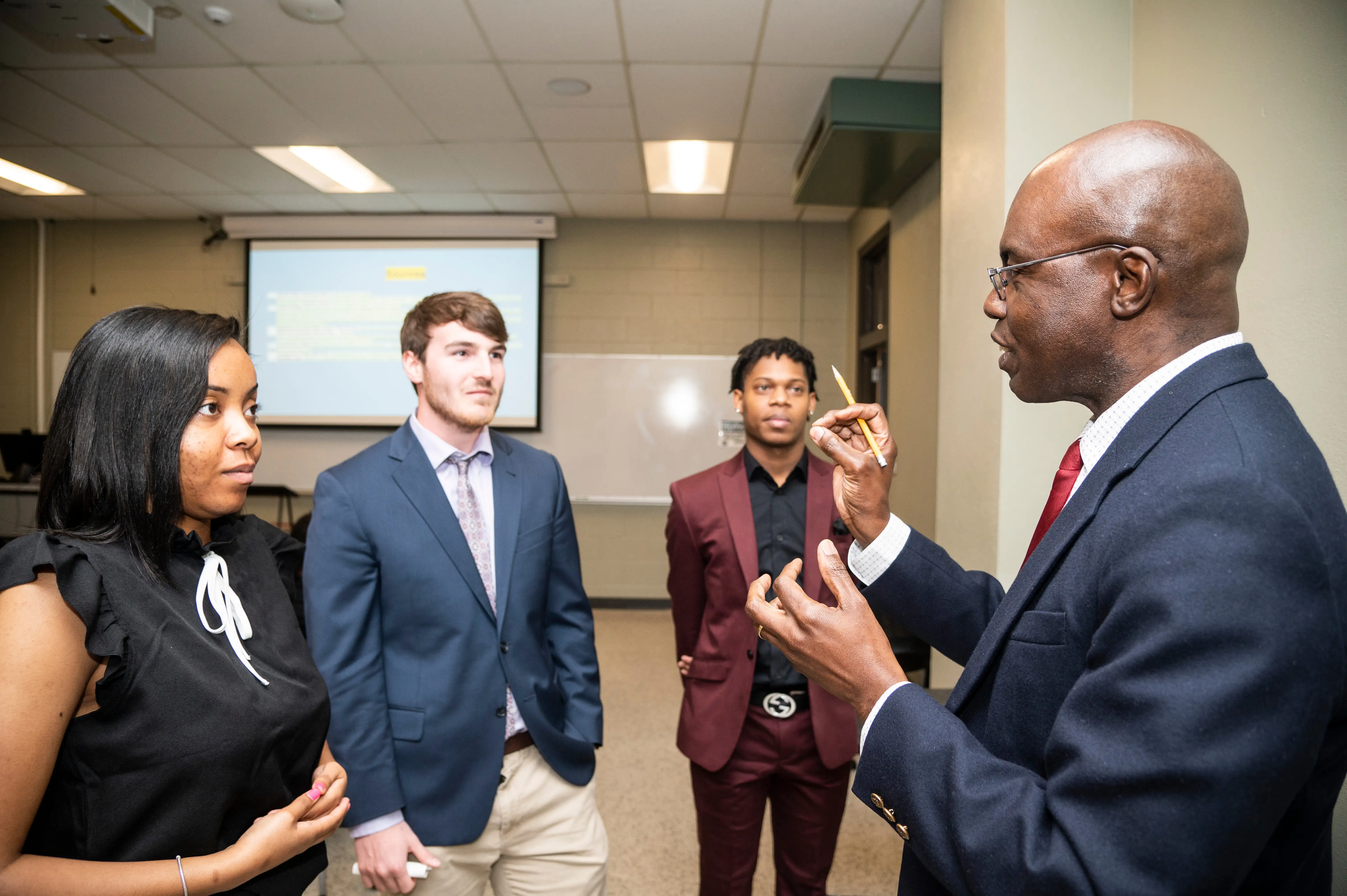 AState Students with professor in mock interviews
