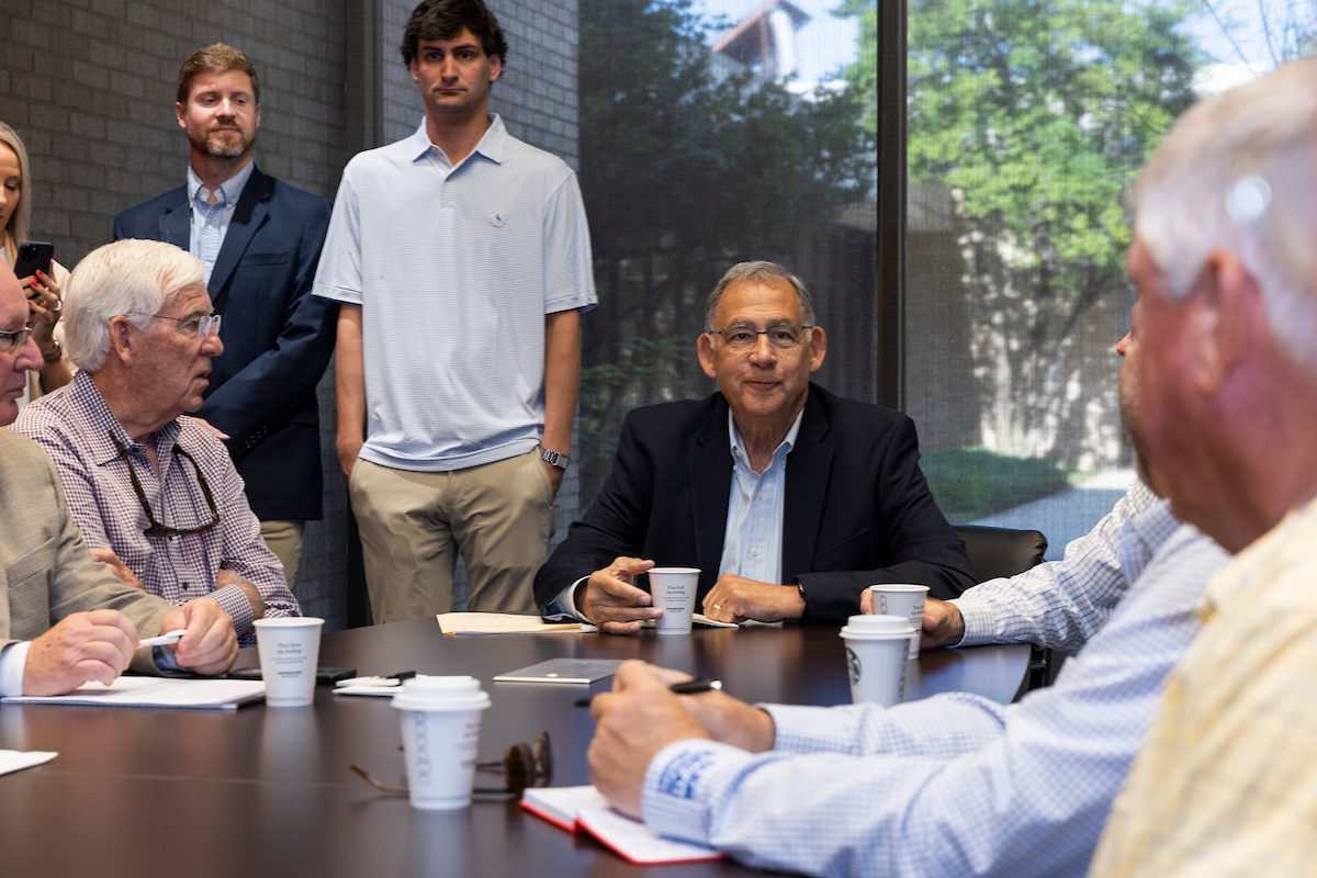 Arkansas State University officials and guests engage in a business roundtable discussion.
