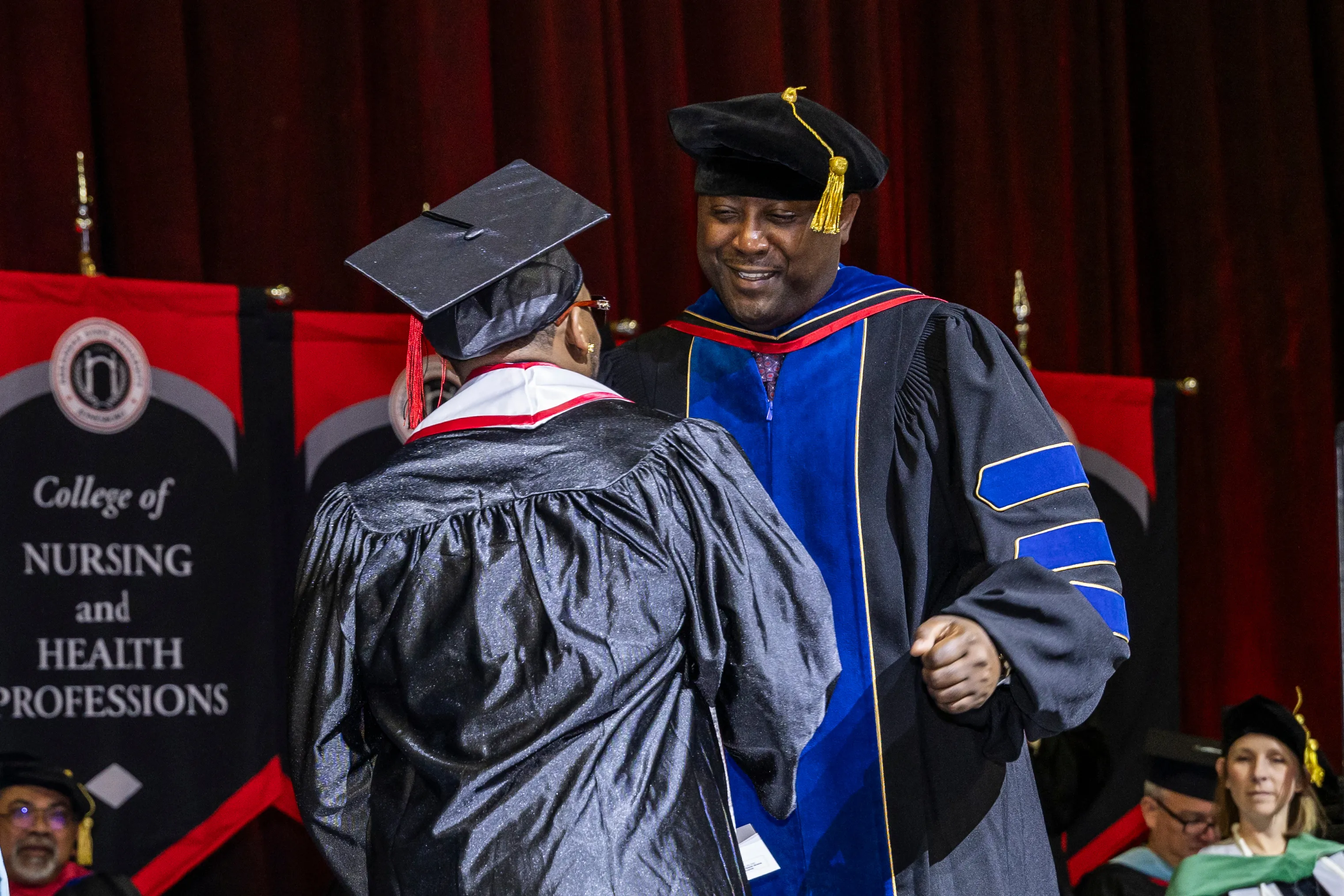 Provost Calvin White congratulates a graduate at a recent commencement ceremony.
