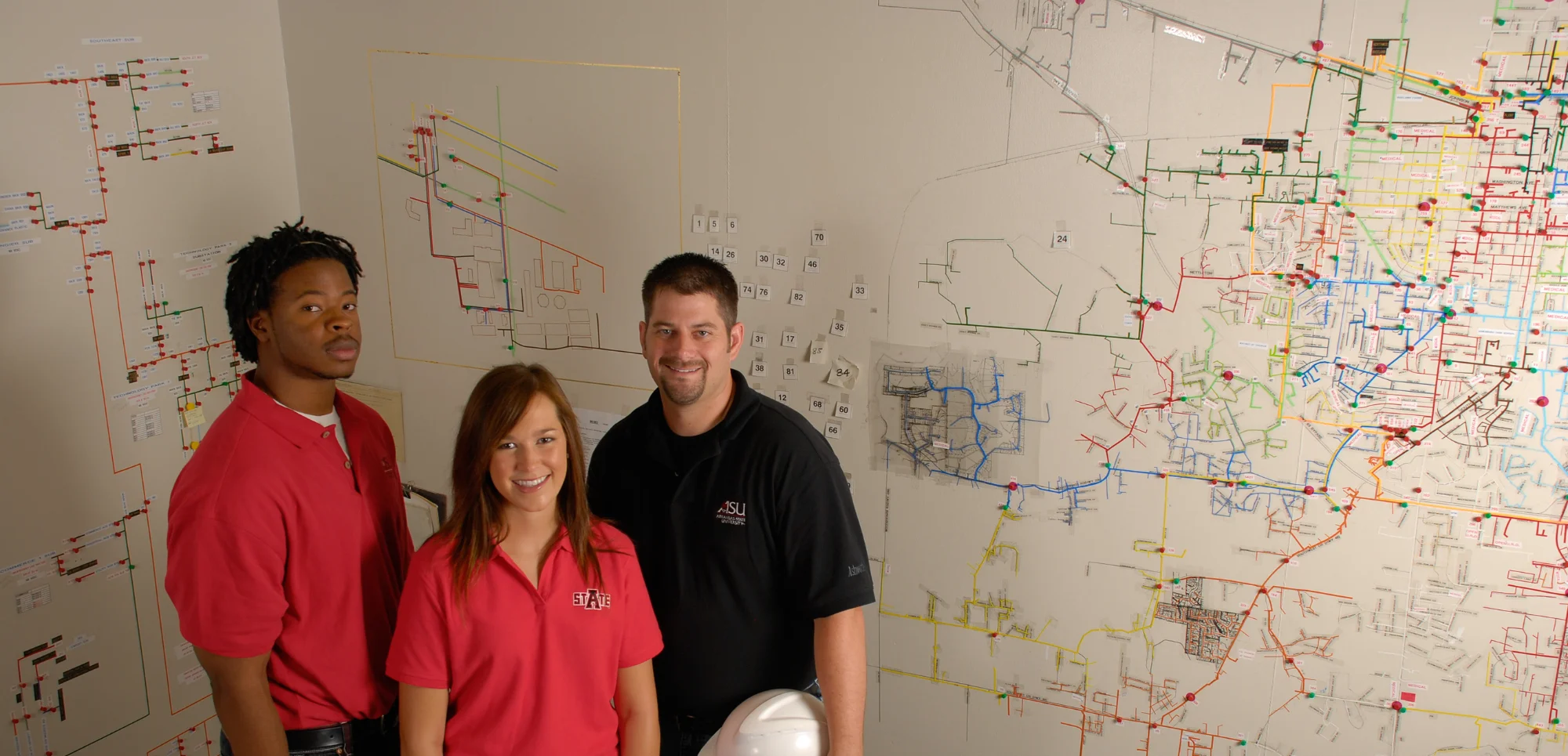 Civil engineering students gathered around a large infrastructure map.